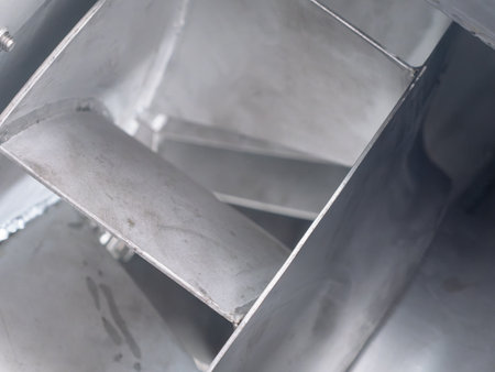 Closeup detail of impeller blades on stainless steel centrifugal fan during production at an industrial workshop. Very shallow depth of field with the nearest edges in focus.の写真素材