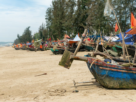 Fishing boats at Sam Son Beach, Thanh Hoa, Vietnam. The boats are built from wood, but covered in fiberglass to last longer.の写真素材
