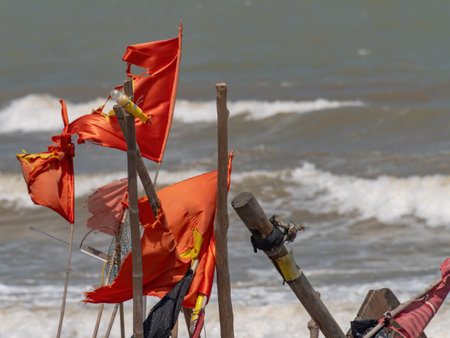 Detail of fishing boats with buoys flying very worn Vietnamese flags at Sam Son Beach, Thanh Hoa, Vietnam.の写真素材
