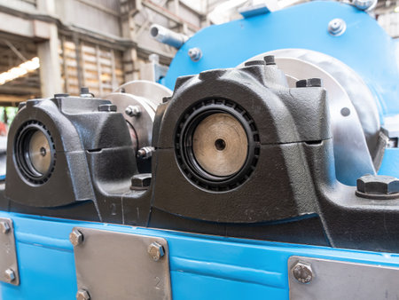 Bearing housings and drive shafts on an industrial twin screw press. Shallow depth of field with the nearest bearing in focus.の写真素材