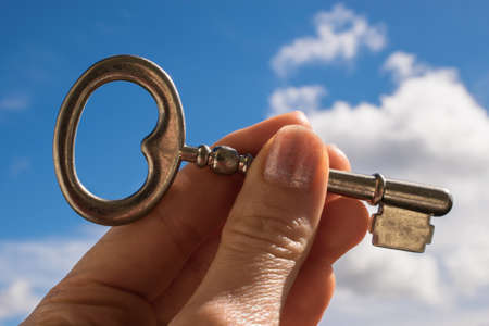 The Key into hand, Sky Backgroundの写真素材