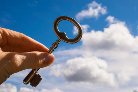 The Key into hand, Sky Backgroundの写真素材