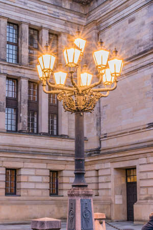 Old-fashioned city street lamp in the nigt. Gendarmenmarkt in Berlin, Germanyの写真素材