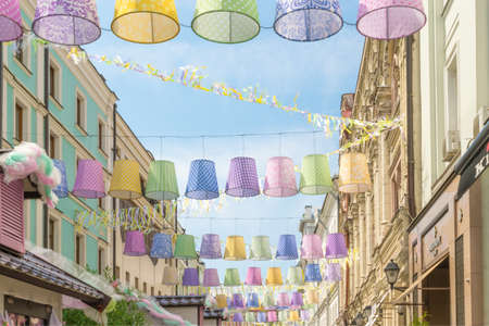 Street decorated with colored paper lantern against sky. Summer celebration.の写真素材