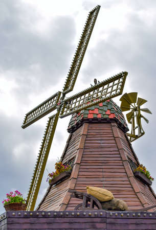 Traditional old wooden windmill with decko against sky.の写真素材