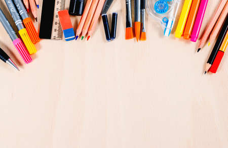 School and office supplies over wooden office table. Top view with copy space. Vertical.の写真素材