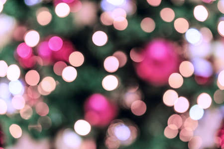 Christmas tree background. Festive abstract background with bokeh defocused lightsの写真素材