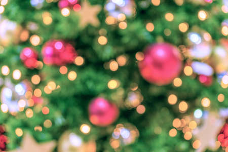 Christmas tree background. Festive abstract background with bokeh defocused lightsの写真素材