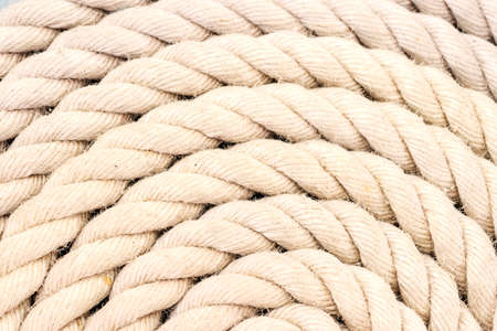 Rope coiled up in circles on a tall shipの写真素材