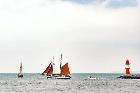 Sailing ships on the sea. Tall Ship and lighthouse Yachting travel.の写真素材