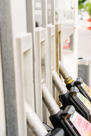 Gas pump nozzles in service station. Benzineの写真素材