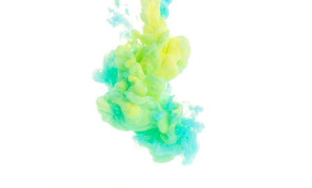 Yellow, blue, and green acrylic colors. Ink swirling in water. Color explosionの写真素材