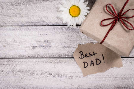Father's day holiday.  greeting card. present gift box on wooden backgroundの写真素材