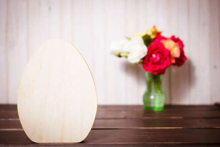 Easter decoration background with wooden egg and flowers. copy space.の写真素材