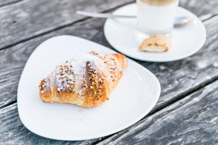 coffee cup latte  and fresh baked croissants on wooden background with copy spaceの写真素材