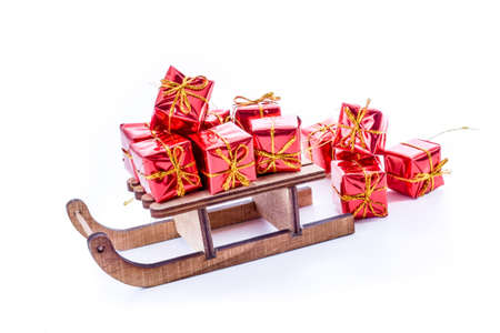 wooden sled toy with red xmas gifts. Christmas and New Year concept. Christmas greeting card.の写真素材