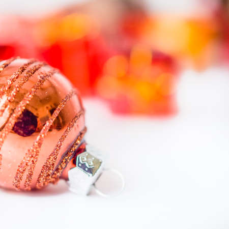 Close-up of xmas ball with blurred colorful Christmas decor in background. Christmas and New Year concept with copy space. Christmas greeting card.の写真素材