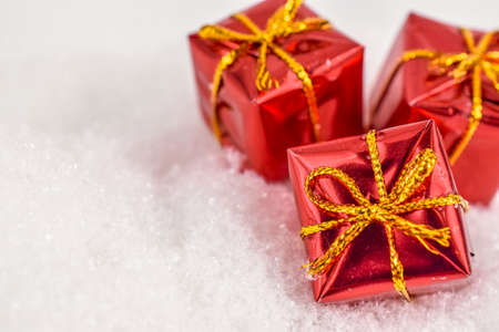 xmas red gifts under snowflakes in snow with copy space. Christmas and New Year concept. Christmas greeting card.の写真素材