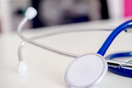 blue stethoscope on white table in doctor's office or in hospital.の写真素材