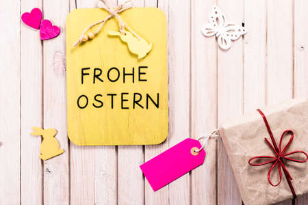 Easter chalkboard decoration background with gift box and blank sale label with copy space. happy easter in german languageの写真素材