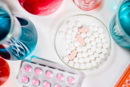 pills and test tubes in laboratory. drug discovery, pharmacology and biotechnology concept. science...
