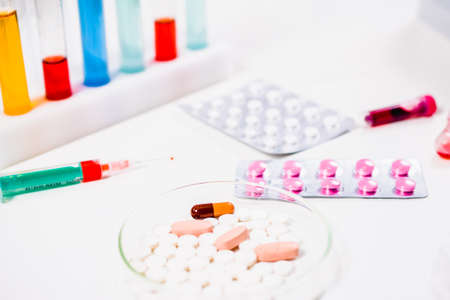 pills and syringe. injection and vaccination. drug discovery, pharmacology and biotechnology concept. science and medical research background with copy space.の写真素材