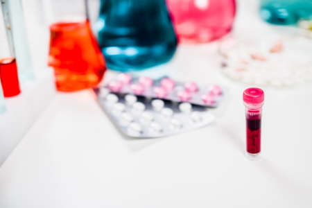 test tubes with blood and pills in laboratory. drug discovery, pharmacology and biotechnology...