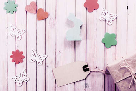 wooden easter rabbit with gift box and blank sale tag. Easter decoration with copy space.の写真素材