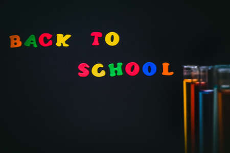 Back to School and Education concept. classroom with laboratory chemical test tubes on chalkboard background. school border with copy spaceの写真素材