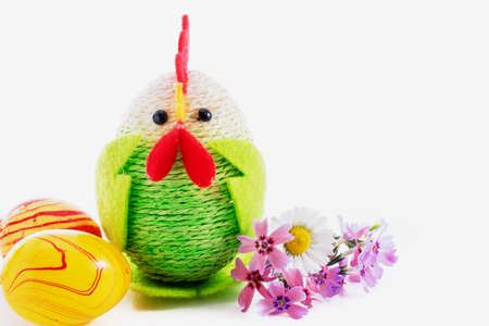 Happy Easter. Colorful easter chick, eggs and yellow featherの写真素材
