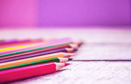back to school. color pencils and colored paper on wooden background with copy space.の写真素材