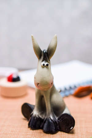 Back to School and Education concept. Toy donkeys surrounded with school supplies. school border...