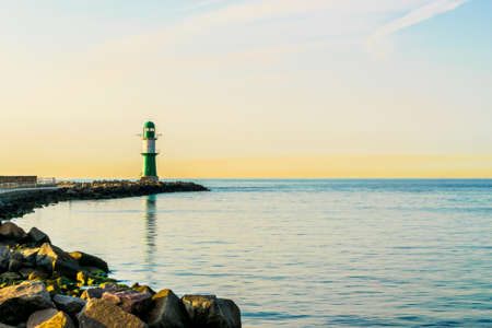 green lighthouse of Warnemuende on the Baltic Sea at the harborの写真素材