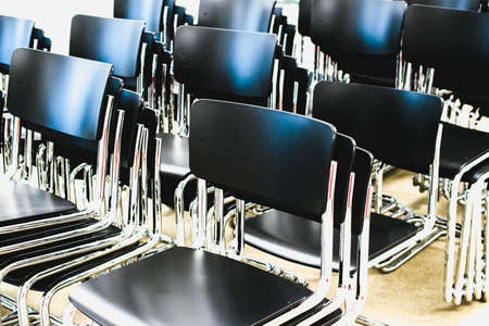 many empty black chairs in meeting roomの写真素材