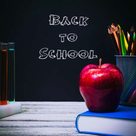 Back to School and Education concept. classroom with apple, books and pencils on chalkboard background. school border with copy spaceの写真素材