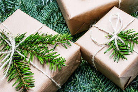 christmas gift. Xmas gifts on wooden background. christmas presents with Fir tree branches. Xmas greeting card and border with copy spaceの写真素材