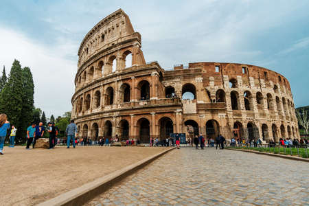 Roma, Italy - april 17, 2018: Colosseum and tourists in Rome. Italy capital landmarks. Colosseum or Amphitheatrum Flavium , a vast amphitheater in Rome. Travel, tourism and attractionsのeditorial素材