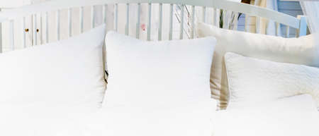 Comfortable white soft pillows on the bed for healthy sleep