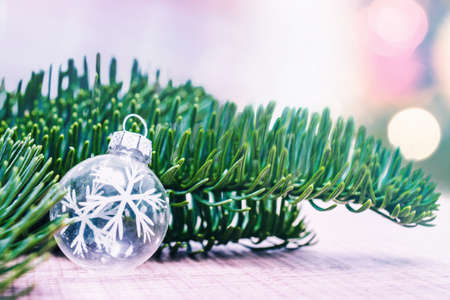 Happy Christmas. white Christmas ball with fir tree branches. Xmas greeting card and border with copy spaceの写真素材