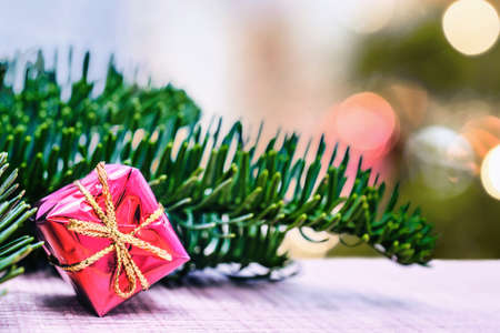 Happy Christmas. Christmas gift on blurred background. Xmas gifts and presents with fir tree branches. Xmas greeting card and border with copy spaceの写真素材