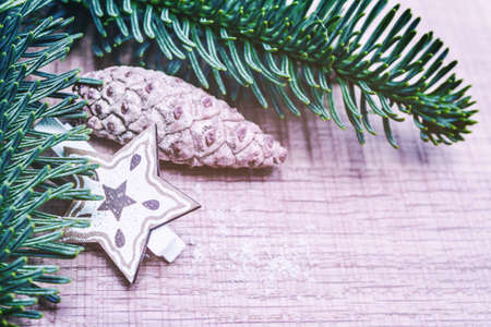 Happy Christmas. Christmas pine cone with fir tree branches on wooden background. Xmas greeting card and border with copy spaceの写真素材