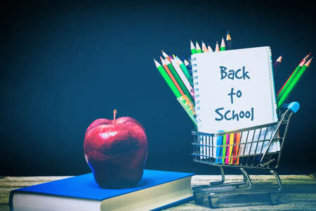 Back to School and Education shopping concept. classroom with apple, books and pencils on chalkboard...