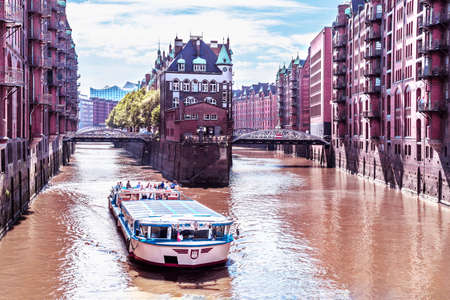 Rostock, Hamburg - July 3, 2018: Hamburg warehouse district with tourist shipのeditorial素材