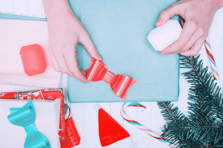 wrapping christmas present on wooden background. Xmas and New Year gift shopping.の写真素材