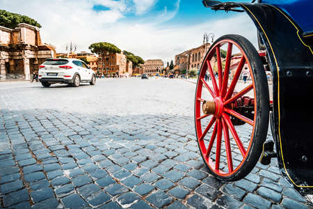 Roma, Italy - april 17, 2018: Colosseum and Forum Roman ruins. Wheel of horse-drawn carriage and tourists in Rome. Italy capital landmarks. Travel, tourism and attractionsのeditorial素材