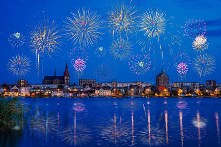 Fireworks in Rostock. Night Panorama view to Rostock in Germany. River Warnow and City port with fireworks during holidays like Hanse Sail, New Year's Eve or Christmasの写真素材