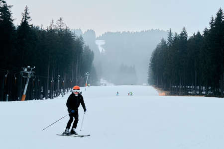 Skier on piste running downhill. ski vacation and winter sports. trawel in winter seasonのeditorial素材