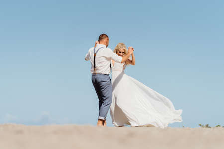 happy newly married couple dancing on the beach. Wedding on the beachの写真素材