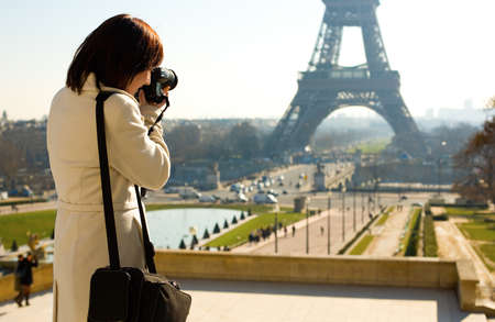 Tourist taking a picture of the Eiffel Tower in Parisの写真素材
