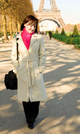 Happy beautiful woman in Paris walking near the Eiffel Towerの写真素材